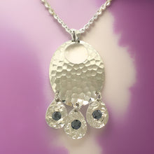 Load image into Gallery viewer, Silver hammered oval shaped necklace with black tourmaline cubic zirconia crystals in a chandelier style necklace with 18” chain